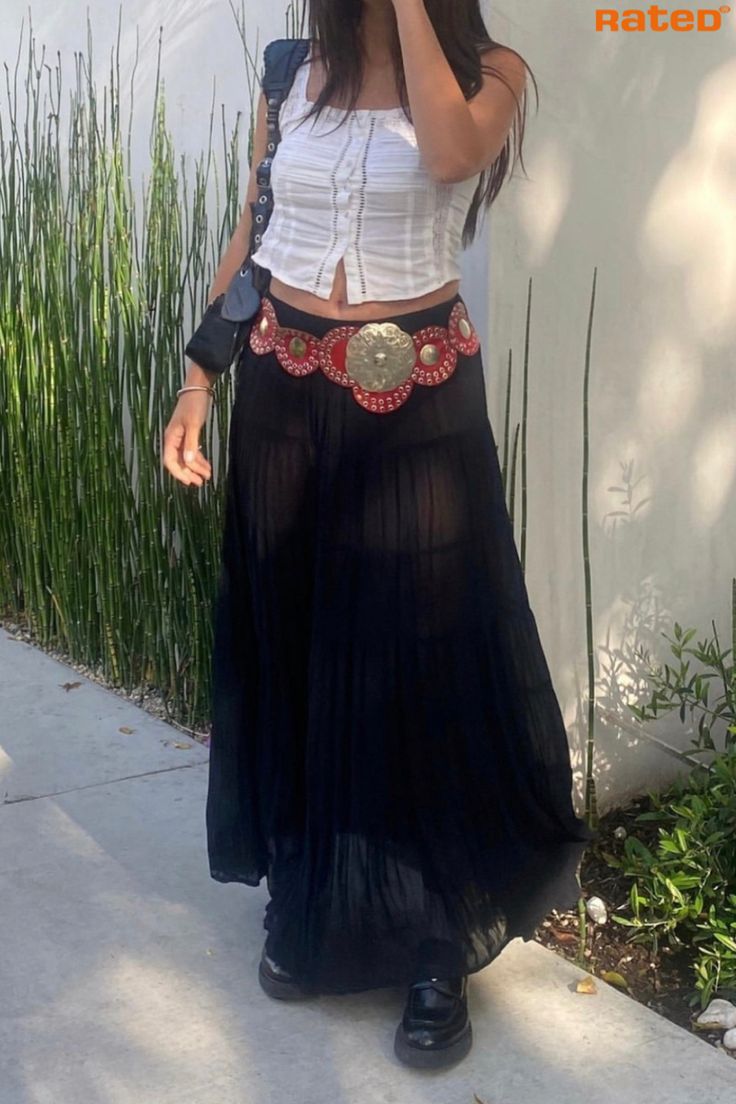 A girl’s outfit wearing a white cropped shirt with a black mesh maxi skirt with a red and gold boho belt Y2k Belt Skirt, Big Brown Belt Outfit, Outfits With Big Belts, Fun Belt Outfit, Skirt With Belt Outfit Y2k, Belt With Skirt Outfit, Bohemian Belt Outfit, Layered Belts Outfit, Fashion Icons Vintage