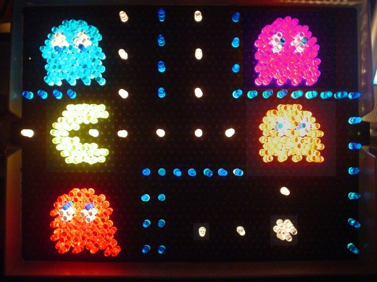 an array of different colored objects displayed on a black board with white dots and blue circles