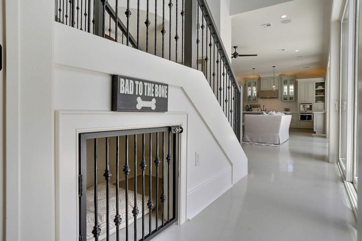 there is a dog gate on the wall next to the stairs in this house that has a sign reading, bad to the bone