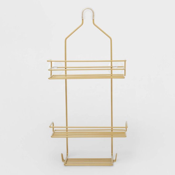 a gold metal and wood shelf with two shelves on each side, one holding a coat rack