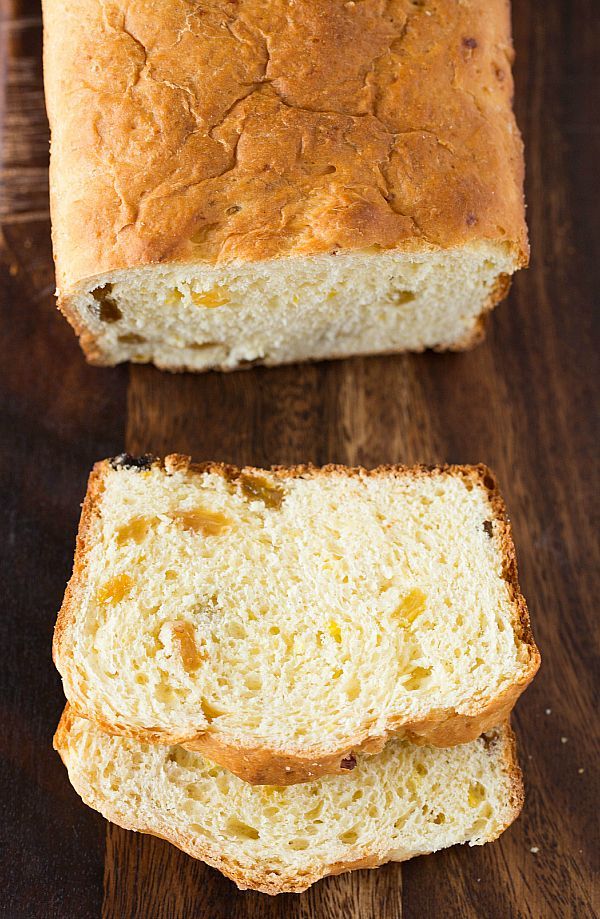 two slices of bread sitting on top of a wooden cutting board next to each other