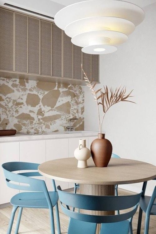 a dining room table with blue chairs around it