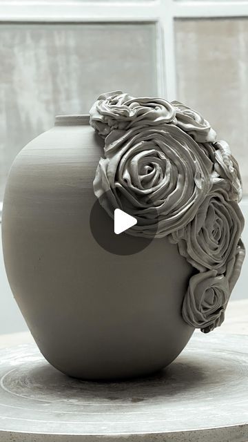 a vase with flowers in it sitting on a table