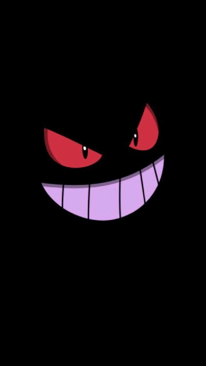 an evil face in the dark with red eyes and fangs on it's teeth