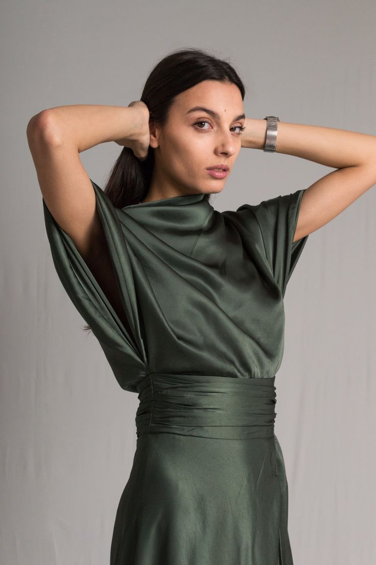 Word on the street is you want to stand out but still look chic. We’ve got you covered girl. The Fiore Dress is an asymmetrical dark sage green silk number, with a cowl neckline and ruched waist detailing. It means business on the right side and party on the left. It takes us 15 hours to make this dress. Check out the pricing transparency HERE. PLEASE ALLOW 1-3 BUSINESS DAYS FOR PRODUCTION Edgy Formal Dresses, Sage Green Bridesmaid Dresses Silk, Wedding Guest Dress Summer Formal, Pear Clothes, Silk Wedding Guest Dress, Dark Green Dresses, Formal Wrap Dress, Simple Silk Dress, Sage Green Dark