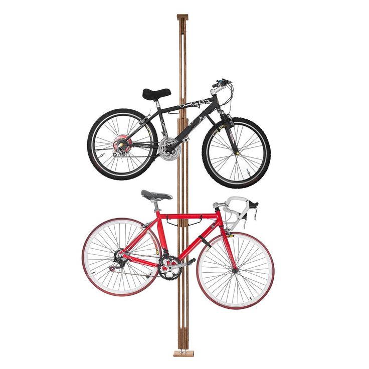 two bicycles are mounted on the pole