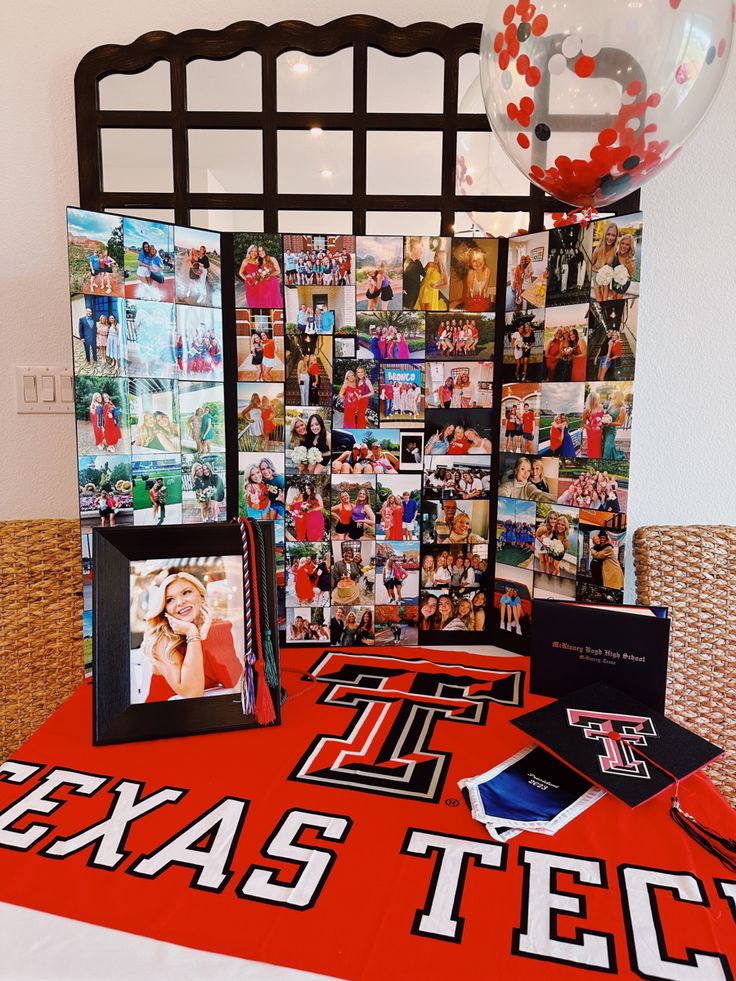 a table topped with pictures and balloons on top of a red cloth covered tablecloth