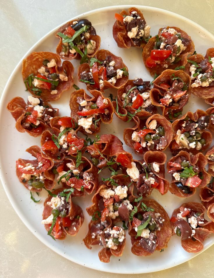 a white plate topped with lots of appetizers on top of a wooden table