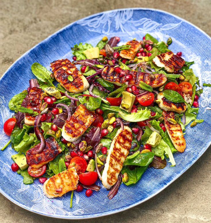 a blue plate topped with salad and meat