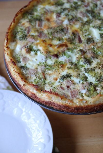 a pizza sitting on top of a pan covered in cheese and broccoli