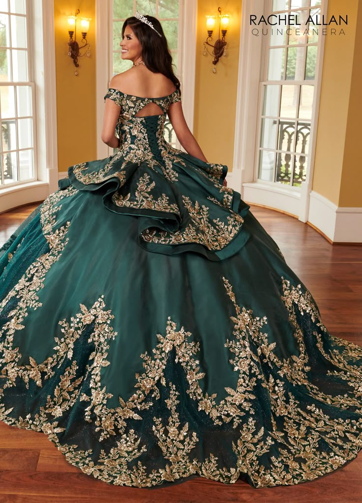 Be the center of attention in this embroidered applique long off shoulder dress with A-line skirt by Rachel Allan RQ2162. Glitter tulle quinceanera ball gown features off-the-shoulder neckline, sequin embroidery, beads, mikado skirt overlay, scallop train, and back with keyhole and lace-up closure. Applique Off Shoulder Quinceanera Dress by Rachel Allan RQ2162 Rachel Allan La Reina Collection: Spring 2023 Style Number: RQ2162 Fabric: Tulle, Glitter Tulle, Sequin Embroidery, Beading, Mikado Pleas Long Off Shoulder Dress, Green Quinceanera Dresses, Quinceanera Dresses Gold, Green Princess, Debutante Ball, Corset Design, Quince Dress, Gold And Purple, Embroidery Beading