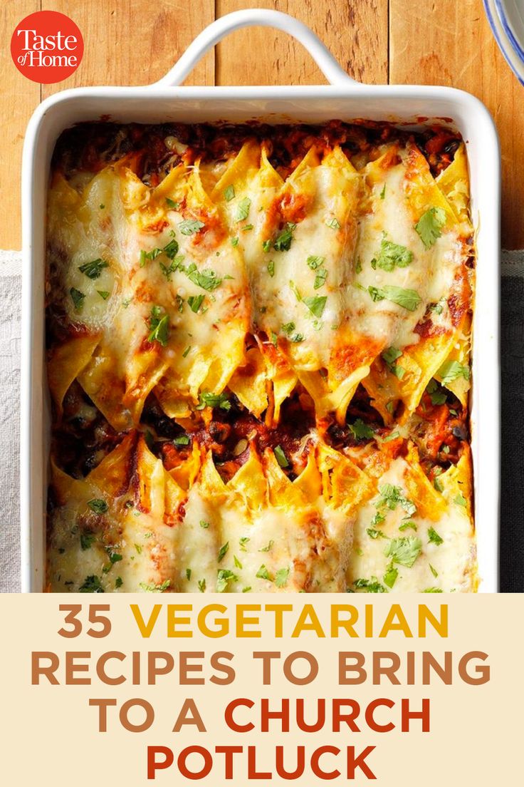 a casserole dish with cheese and vegetables in it, on top of a wooden table