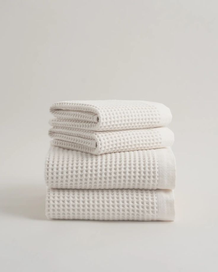 three white towels stacked on top of each other