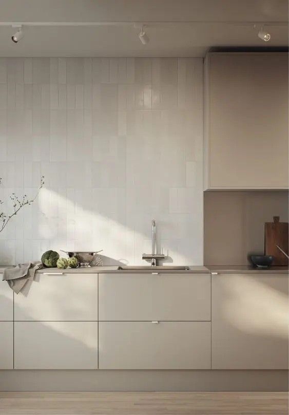 a modern kitchen with white cabinets and counter tops is pictured in this image from the side view