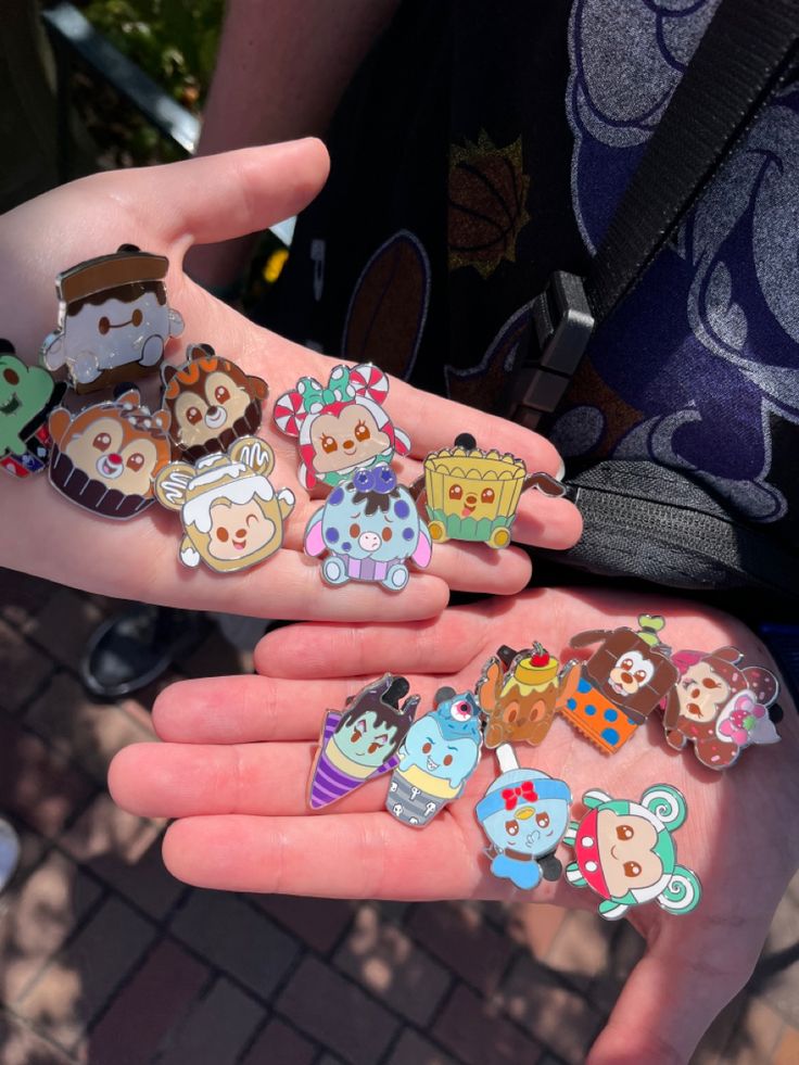 a person holding several small animal stickers in their hands