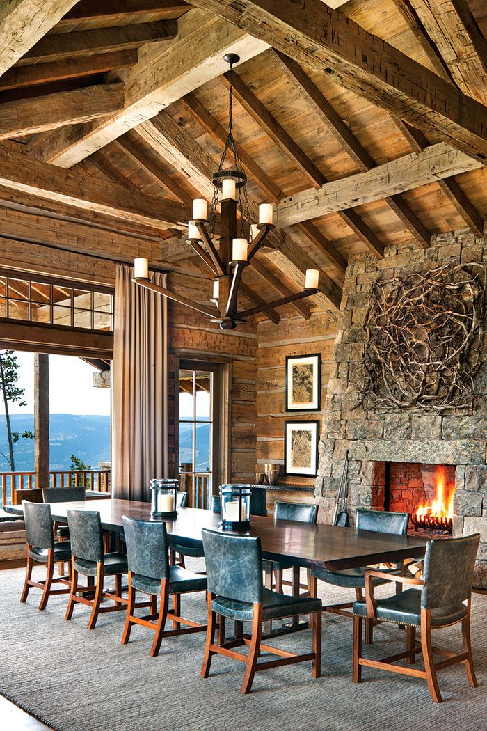 a dining room table with chairs and a fire place in the middle of the room