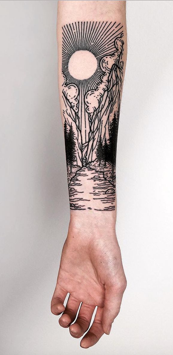 a person's arm with a black and white tattoo design on the left forearm