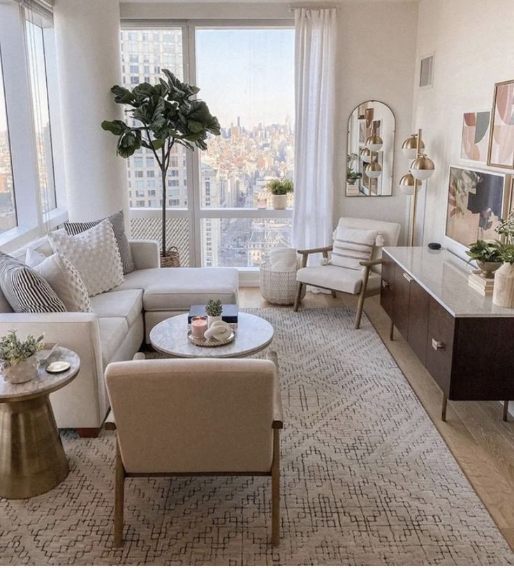 a living room filled with furniture and a large window