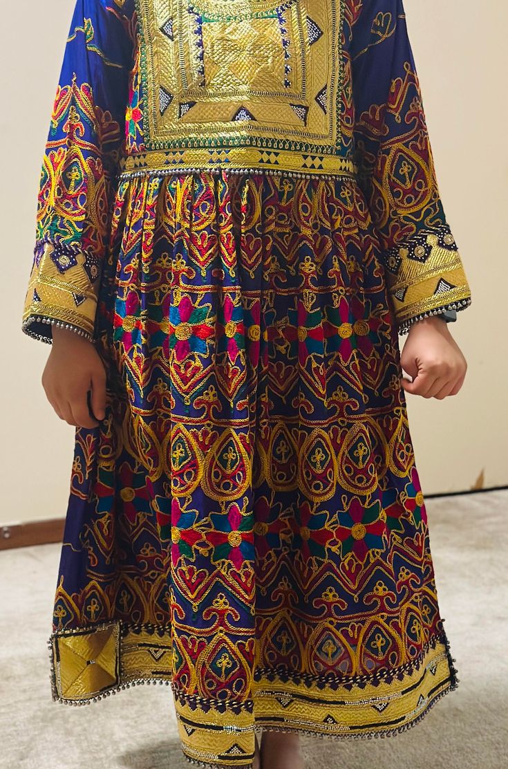 Afghan women's dress is a traditional handmade women dress called jawlie. It's made of Jawlie fabric, Zartar, rhinestones and jingle bells. Traditional Multicolor Long Sleeve Maxi Dress, Eid Tunic Dress With Mirror Work, Eid Mirror Work Tunic Dress, Folk Style Tunic Dress With Traditional Patterns, Festive Tunic Dress With Traditional Patterns, Traditional Tunic Dresses For Festivals, Traditional Tunic Dress With Multicolor Embroidery, Traditional Festive Tunic Dresses, Folk Style Dresses With Traditional Patterns For Eid