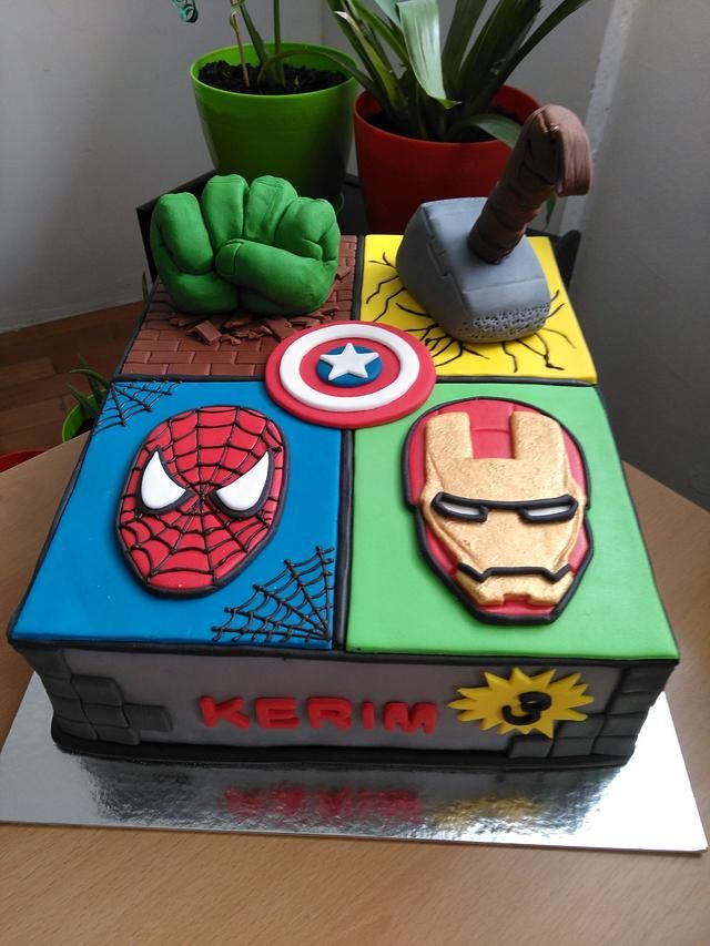 the cake is made to look like it has been decorated with superheros and spider - man