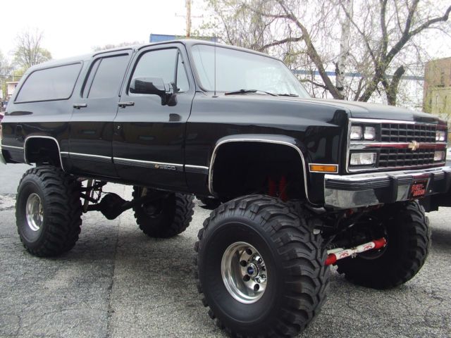 a large black truck parked in a parking lot