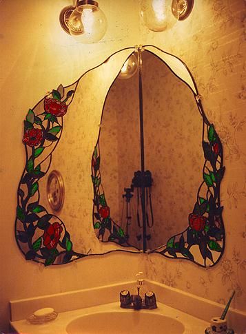 a bathroom with a sink, mirror and lights on the wall in front of it