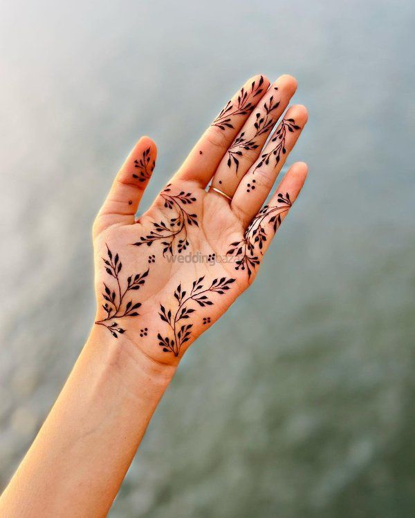 a woman's hand with hendix on it, holding out her palm