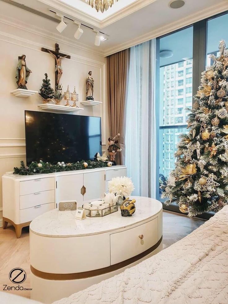 a living room decorated for christmas with a large tv and tree in the corner next to it