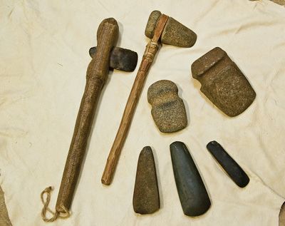 an assortment of rocks and hammers laid out on a piece of paper