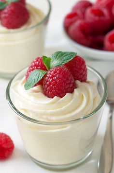 two small desserts with raspberries on top