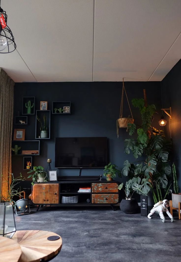 a living room filled with furniture and a flat screen tv on top of a wooden stand