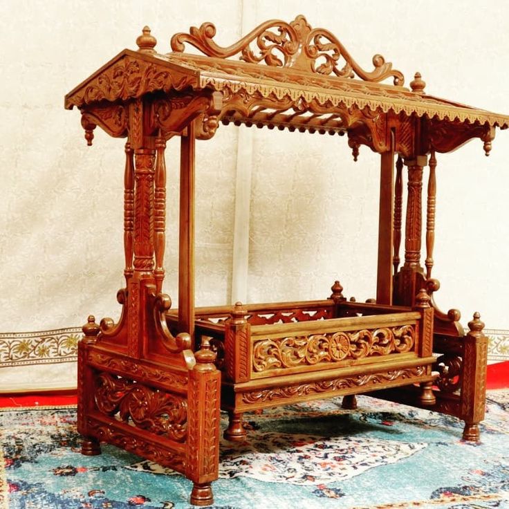 a wooden bed sitting on top of a rug