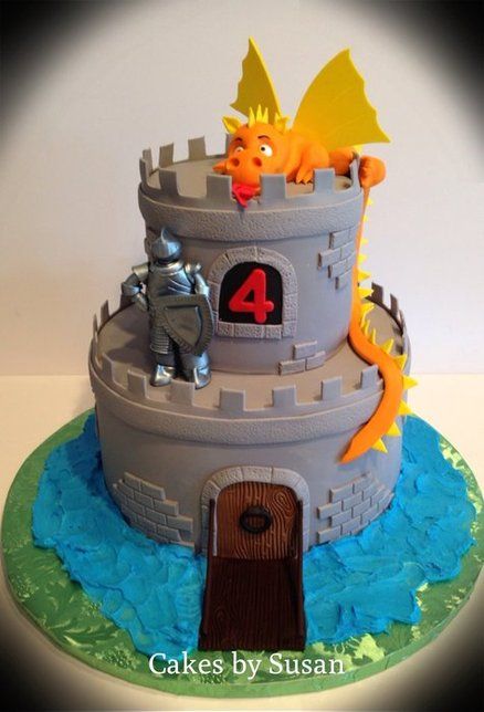 a birthday cake with a castle and dragon on it