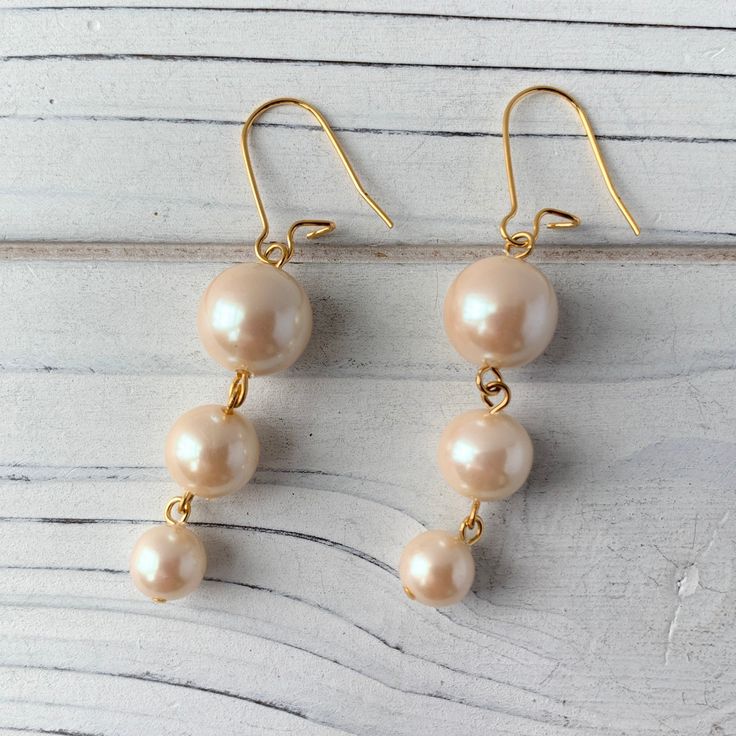 Simple and sophisticated pearl drop earrings. Pearls never go out of style! These make great bridal party gifts. Earrings have 2 1/4 inch drop. Nickel free, gold plated brass ear wires. Thank you for visiting my Etsy! Gold Linear Earrings With Pearl Drop For Party, Gold Linear Pearl Drop Earrings For Party, Drop Pearl Earrings With French Hook For Wedding, French Hook Pearl Drop Earrings For Wedding, Gold Pearl Earrings With Ear Wire For Party, Elegant Gold Pearl Earrings Nickel-free, Wedding Pearl Drop Earrings With French Hook, Cream Pearl Earrings For Party, Elegant Gold Pearl Earrings Nickel Free