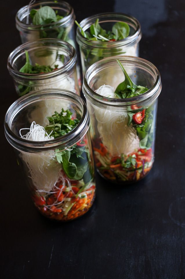 four mason jars filled with different types of food