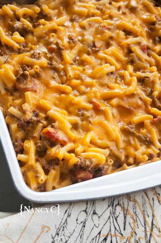 a casserole dish filled with cheese and meat