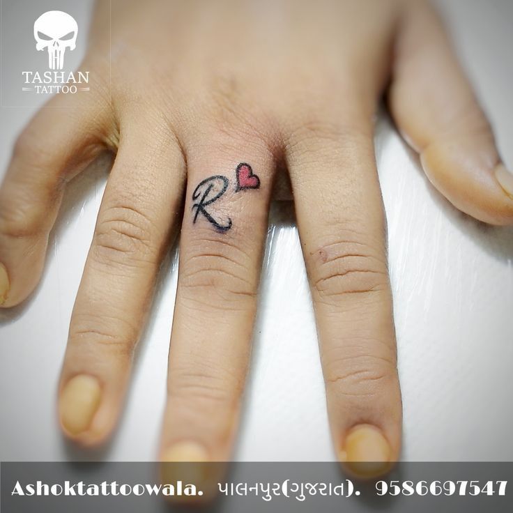 a person with a small tattoo on their finger