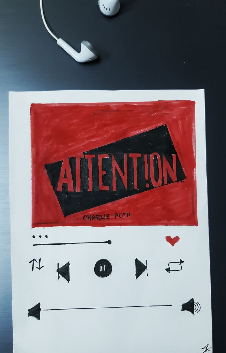 a piece of paper with the word attention on it next to headphones and earbuds