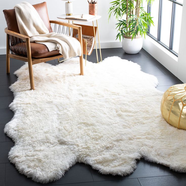 a living room with a white rug and chair