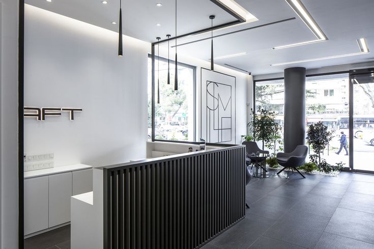 the interior of a modern office building with white walls and black metal radiator