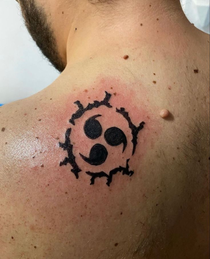 a man with a tattoo on his chest has an image of a dog's paw in the shape of a sun