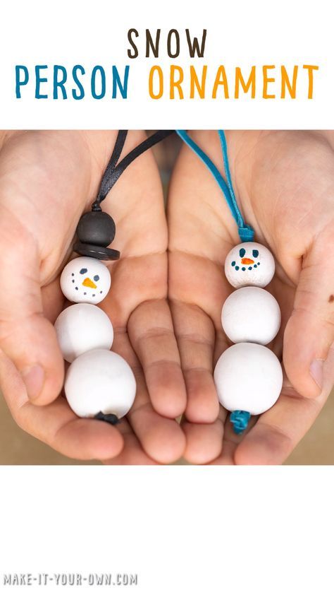 two hands holding snowman ornaments with text overlay