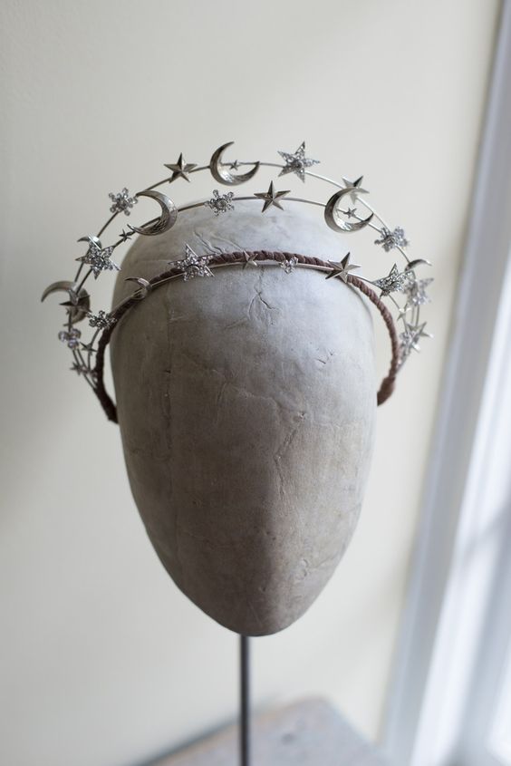 a headdress with stars and moon decorations on it