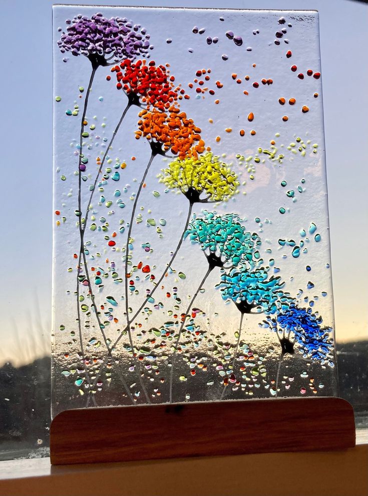 a glass block with flowers painted on it