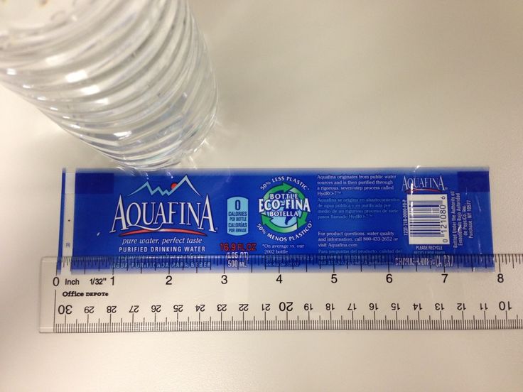 there is a plastic ruler with a water bottle next to it