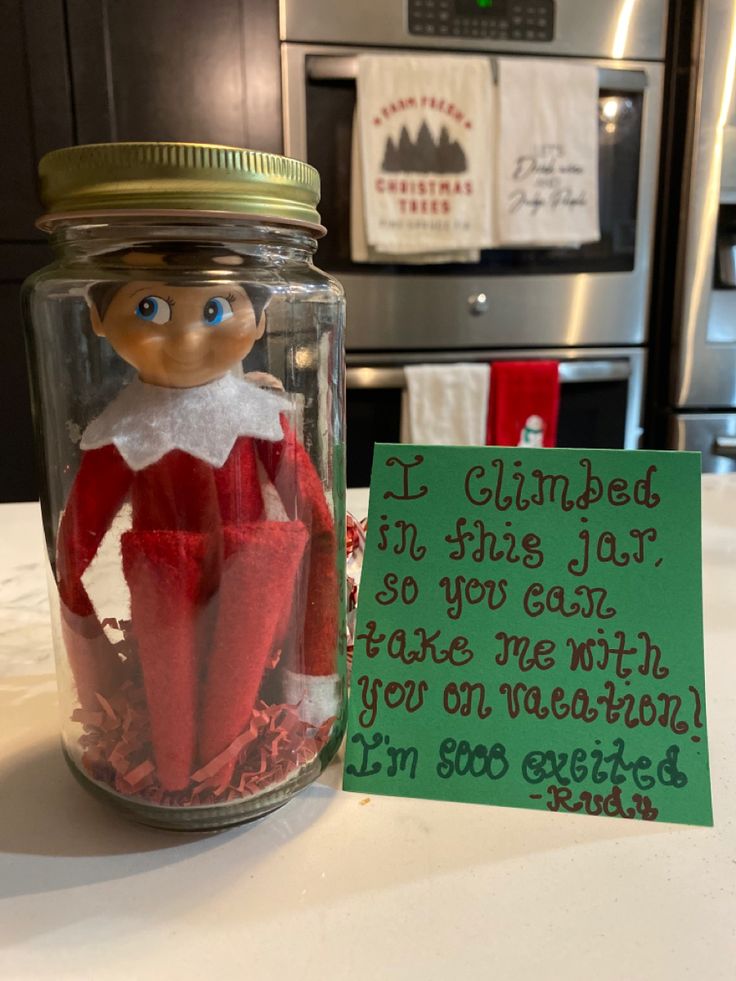 an elf in a jar with a note attached to it