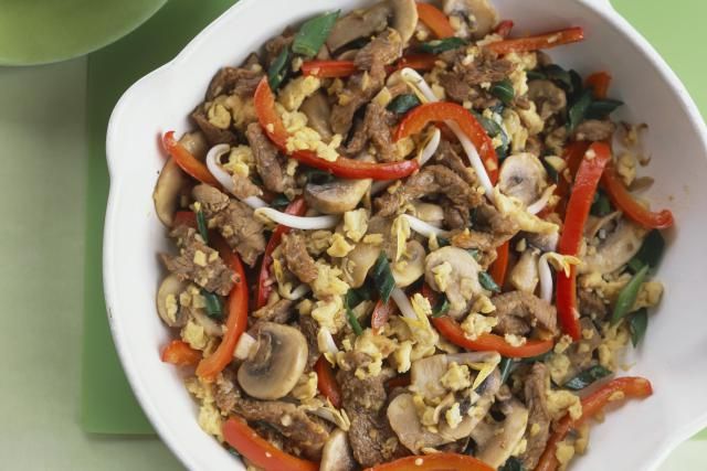 a white bowl filled with vegetables and meat