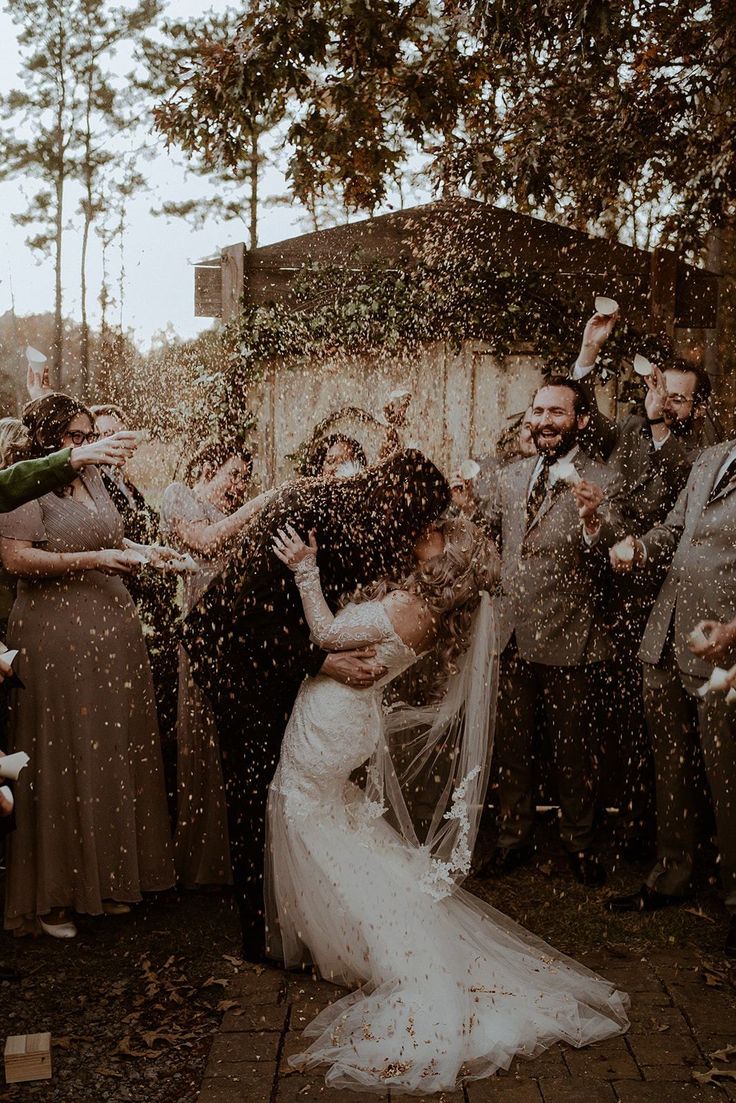 a bride and groom are surrounded by confetti