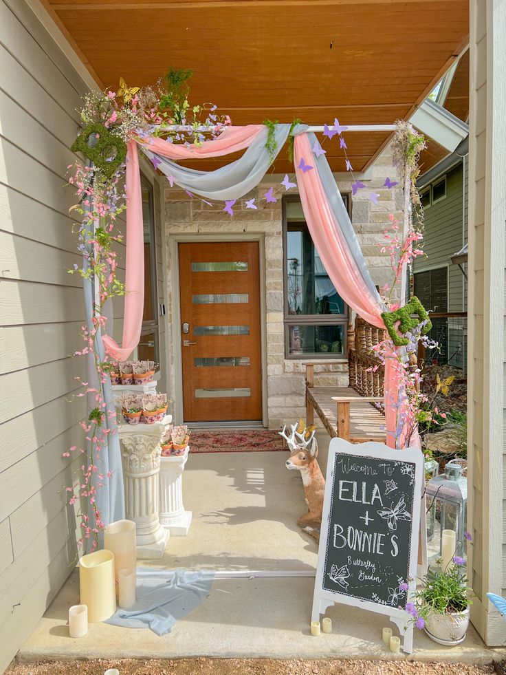 the entrance to a house decorated with flowers and ribbons for an outdoor wedding or bridal party