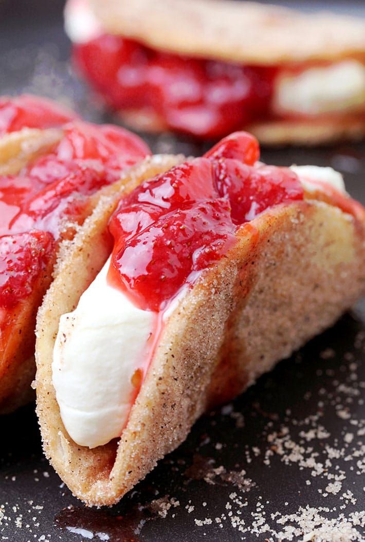 two hot dogs covered in ketchup and marshmallows